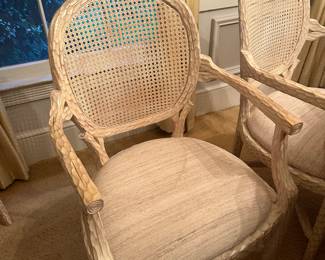 Set of 8 Faux Bois style French cane back chairs, made of wood carved to look like branches. Cane backs provide ample support while giving an airy appearance. The chairs are upholstered in a neutral, textured fabric that perfectly complements the washed blonde wood finish. 