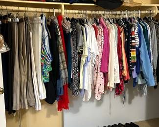 Closets filled with ladies clothing.