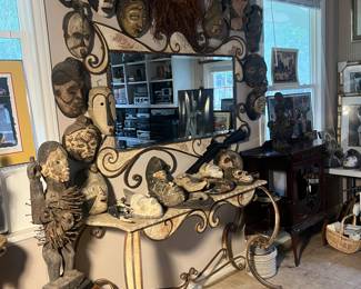 The mirror in this picture sold to include the mask at the very top center. 