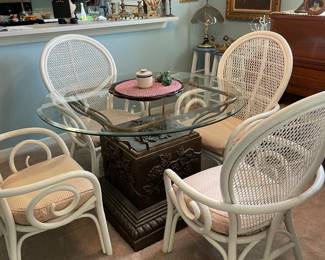 Round glass table with four rattan chairs 