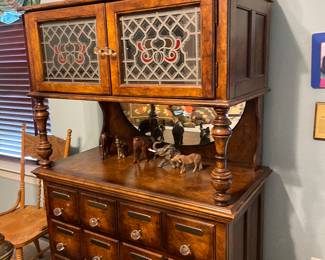 Unusual Chest of Drawers. Beautiful Apothecary  by Pulaski with brass plates of Latin names of exotic remedies. Lighted stained glass doors. Crystal knobs 