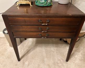 Small table. Top drawer is a drawer. bottom 2 drawers have fold out legs to become additional tables. See next photo
