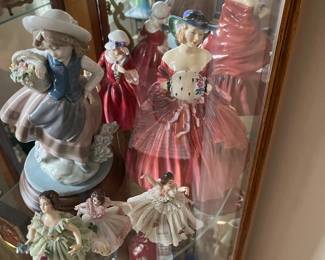 On the left is Lladro figurine “Sweet Scent Girl.”  The lady on the right in the ballgown is Royal Doulton “Genevieve.”