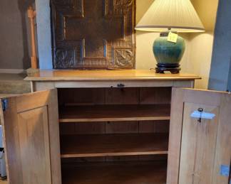 2-door 42 inch wide cabinet, open. Metal Wall Art.  Green Ginger Jar Lamp