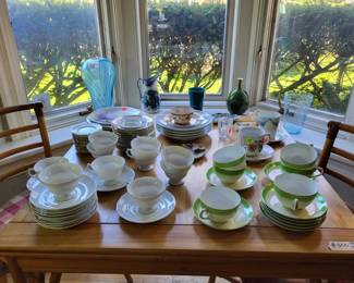 Extendable table with china tea cups, plates, etc.