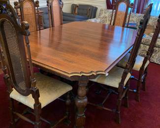 #8	Polish Black Walnut Dining Table w/carved Legs - Table hand-cranks out to add 4 leaves with 6 tall carved chairs.  Dining Table has ornate Feet   Size 	 $600.00 
