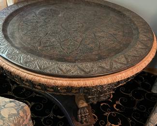 Round etched metal clawfoot accent table on marble base