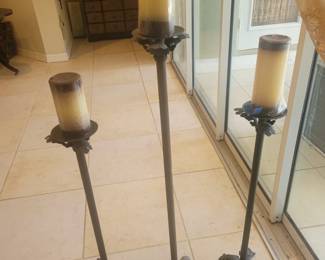 Set of three candle holders with candles
