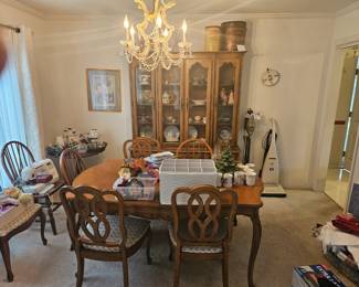 Large dinning room table, leaf on the side. Crystal wine glasses and high ball
