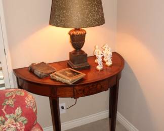 more antiques! a table and an antique lamps with some antique books on top