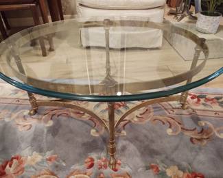 Vintage brass table with thick glass top.