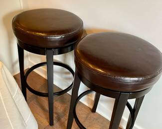pair of faux leather bar height swivel stools