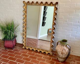 large ornate gold scalloped mirror, pottery jug, artificial grass in metal planter