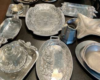 lots of pewter and aluminum serving pieces