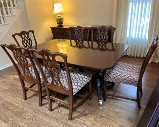 Baker Furniture dining table with 4 (12"W) leaves, table pads, 2 captains chairs and 6 side chairs