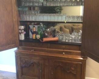 Country French cabinet opens to a bar