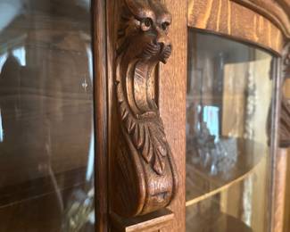 Close up of carved Griffin on china cabinet.