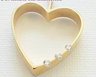 14 kt gold heart pendant with 3 brilliant cut diamonds.