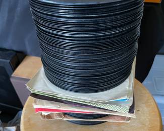 Stack of 45’s about 8” high. Mostly rock from the 70’s and the 80’s.