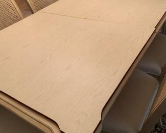table pads are cut and have faux wood grain, there are also pads for the leaves