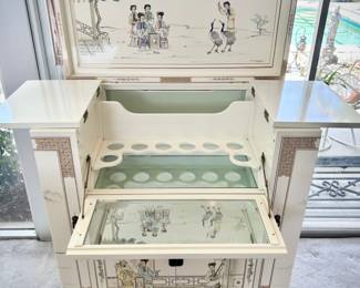 Ivory chinoiserie pulldown wet bar. Both sides open to hold wine glasses, bottom opens to hold bottles, and top opens for bar.