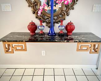 Black marble wall-mounted entry table with gold Asian detail (buyer must bring tools to remove) 