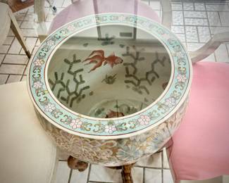Breakfast table made of giant Chinese planter, stand, and round glass top. Also includes four ivory chairs with pastel seats.