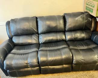 Blue leather sofa with recliner on each end