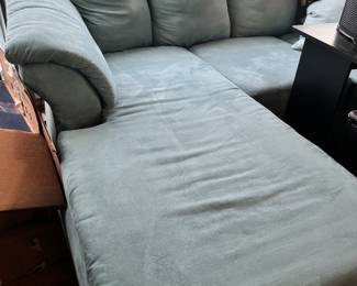 Light blue sofa with chaise lounge end