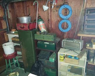 Garage has lots of vintage tools and cabinets 