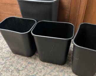 4 black trash cans