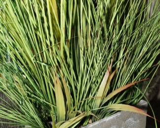 Faux grass in stone planter
