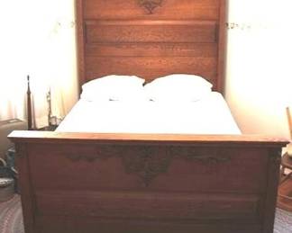 148 - Vintage carved oak full size bed with bedding 73 x 59 x 79
