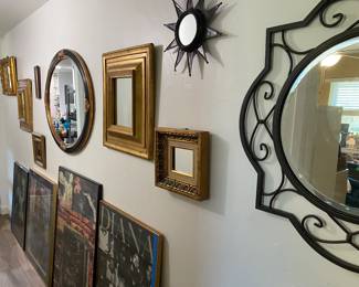 Assortment of mirrors and art in hallway