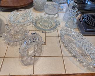 Pressed glass grouping with cruets, bowls, small dishes, and oval dish 12"L
