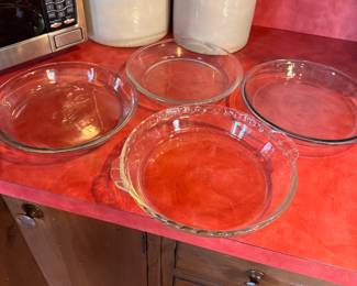 Group of clear pie pans, Pyrex, Glasbake, and Anchor Hocking