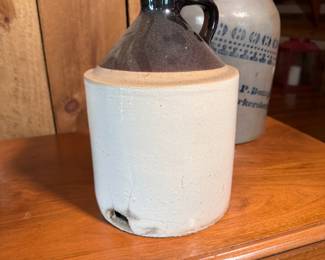 Brown and cream pottery jug, has some chips and a large hole on the lower side 10"H