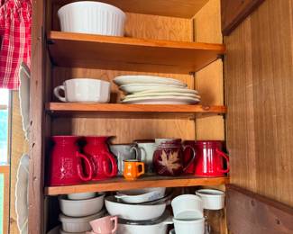 Cabinet lot with baking dishes, plates, ceramic and pottery mugs
