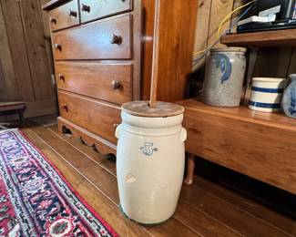 White Hall pottery 5-gallon butter churn with lid and paddle, does have some chips, a hairline, and a repaired crack on the base, has an attached carpet pad to the bottom