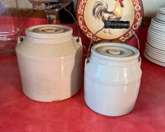 Two stoneware lidded crocks with handles, some wear and chips, tallest is 7"