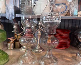 Two clear glass oil lamps with flared fluted base and one chimney says 'Home Sweet Home' 16"H