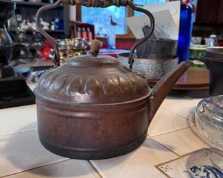 Antique copper large tea kettle with wooden handle, ovoid band, has an indention below spout, body is 9"H