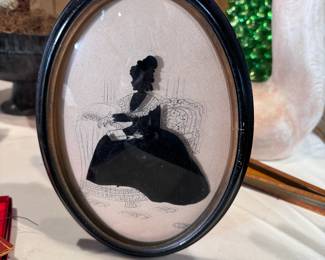 Reverse painted seated Victorian woman silhouette in oval frame 10"