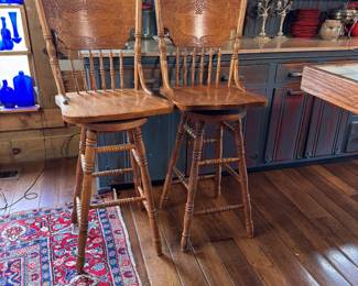 Pair of bar-height carved oak swivel stools, mild wear and rubs, 46"H x 18"W