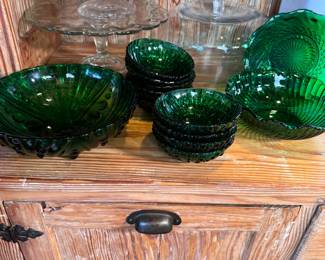 Group of emerald green serving and small dishes, variety of Anchor Hocking patterns, largest is 8"W