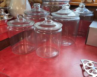 Lot of clear glass canisters, largest is 13"H