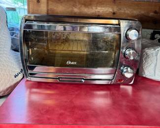 Oster stainless toaster oven, needs minor  cleaning, works well 20"W 