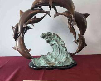Bronze sculpture on wooden base dolphin and wave artist name IS OH