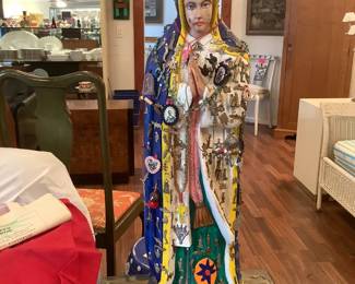 Virgin statue with milagros