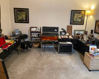 Room full of vintage guitars, audio equipment. 